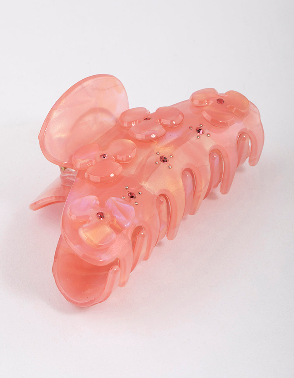 Showcasing a blush acrylic flower diamante hair claw clip with floral design in pink and light coral front view
