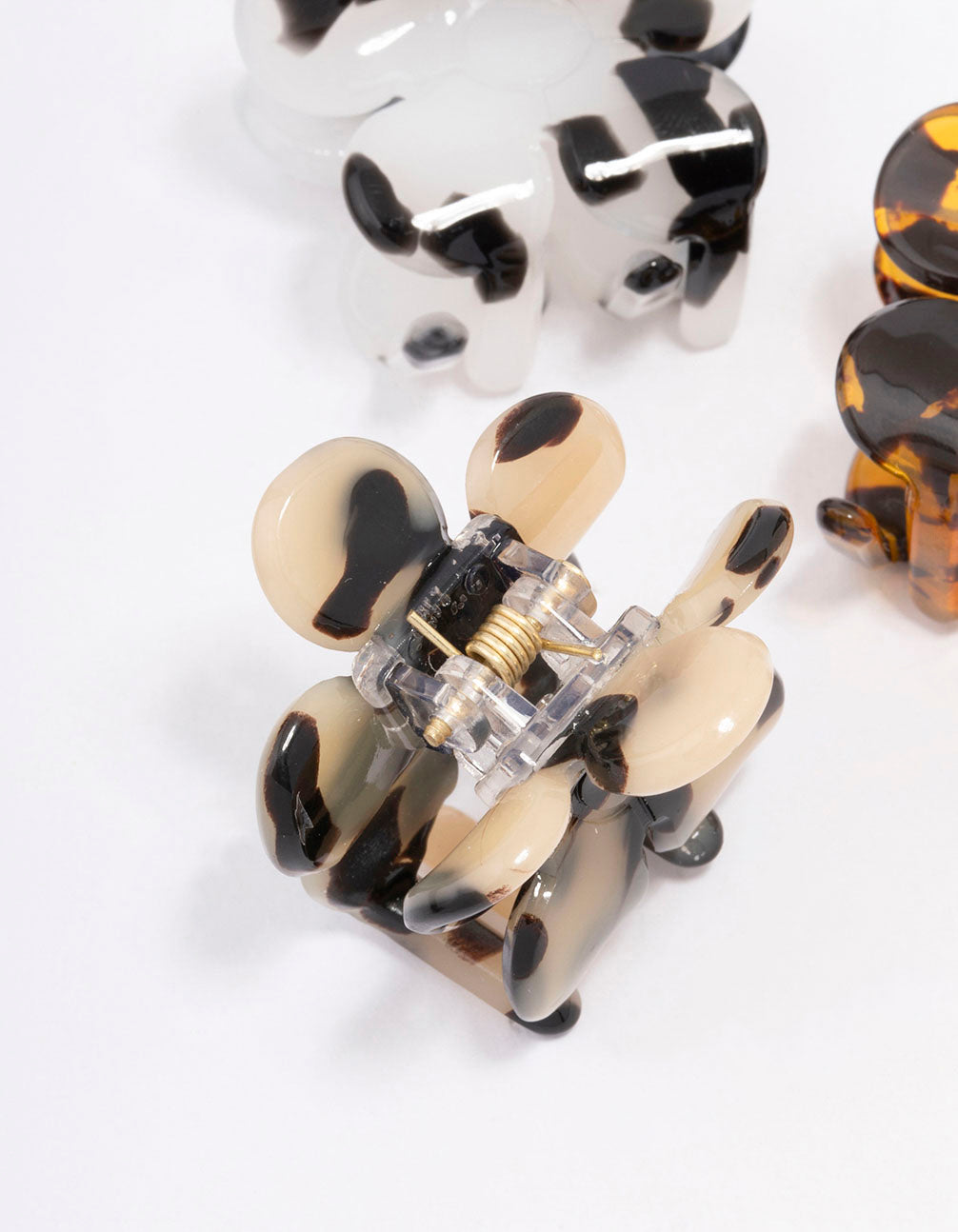 Shop small daisy hair claw clips in 3-pack with floral tortoiseshell pattern featuring black, white, orange, and beige side view