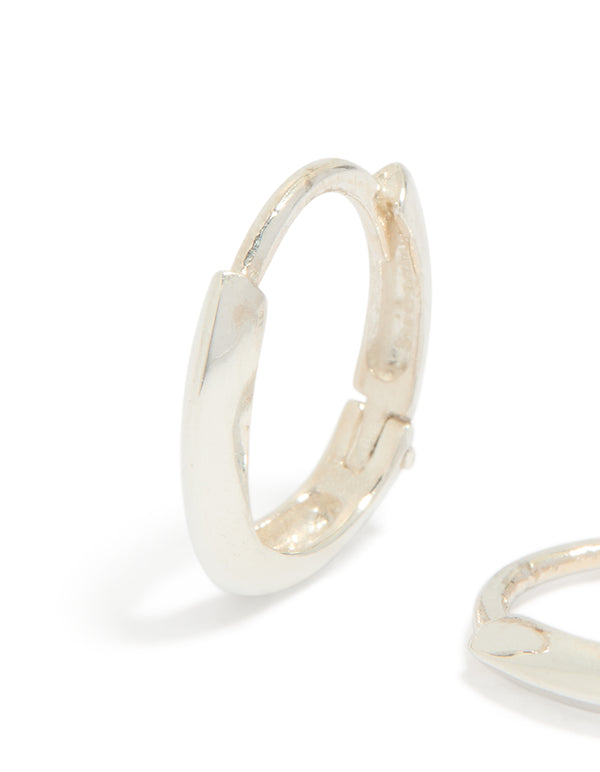 Highlighting chubby hoop earrings crafted from sterling silver with oval cut in a polished finish close up view