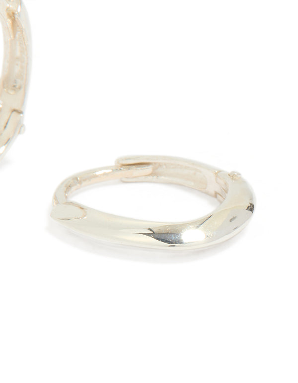 Displaying chubby hoop earrings crafted from sterling silver with oval cut and polished finish post detail view
