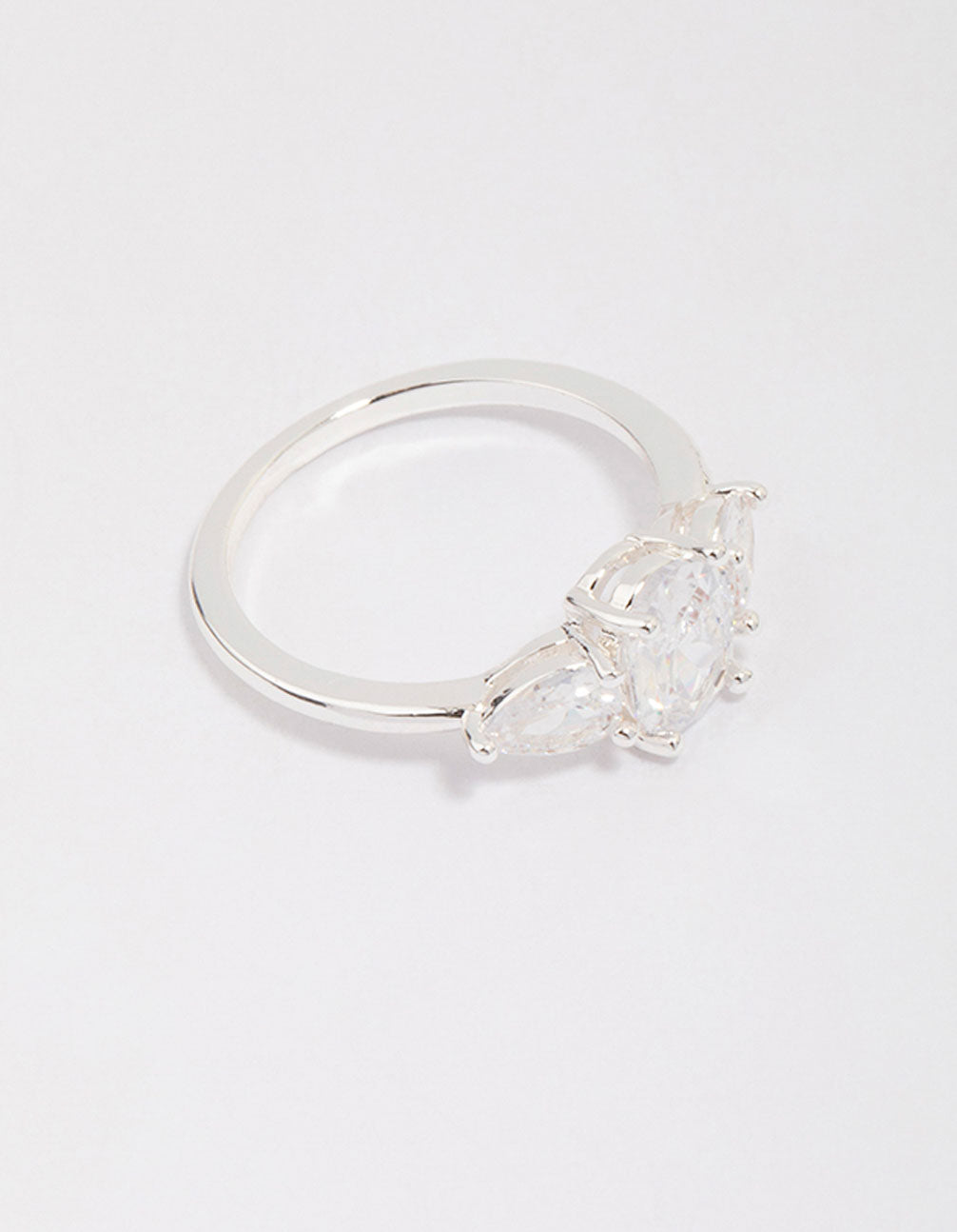 Showcasing a silver plated oval enchanting ring with stone cut design side detail view