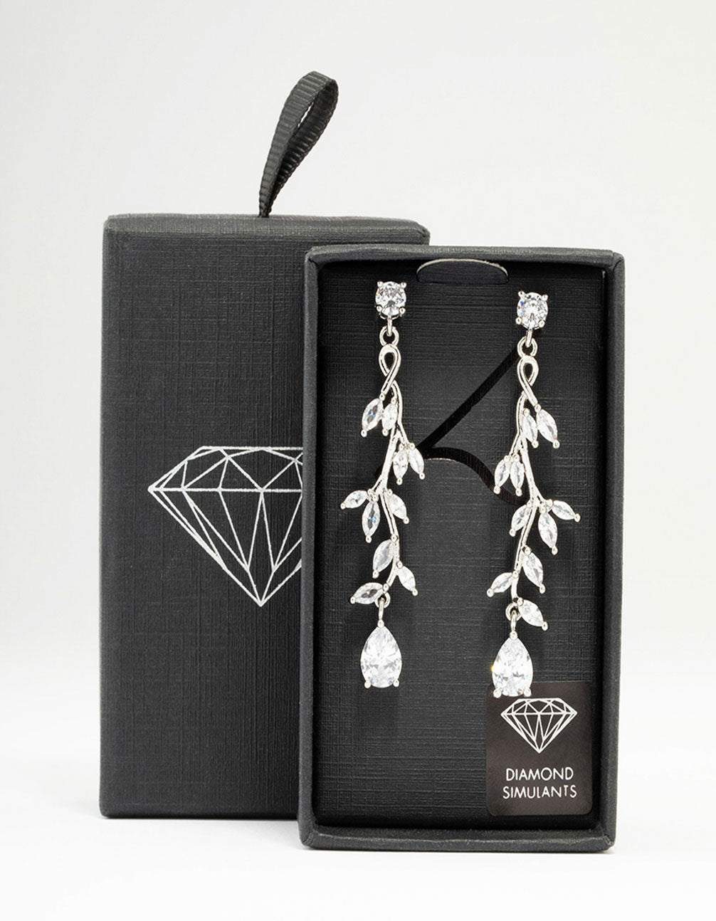 Showcasing silver cubic zirconia vine leaf drop earrings with clear stones in a front view
