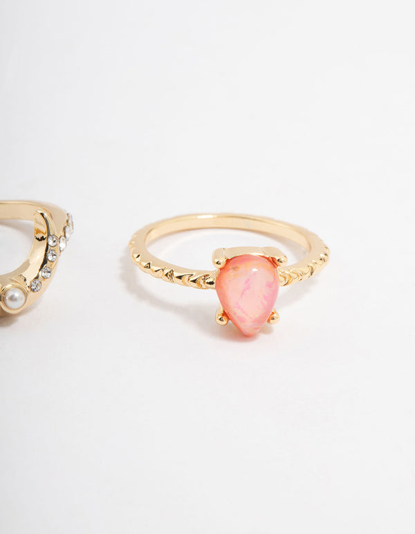 These celestial dainty stacking rings in gold plated material showcase pear stone cut and pearl details close up view
