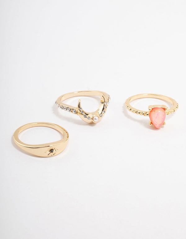 Featuring celestial dainty stacking rings crafted from gold plated material with pear stone cut and pearl accents front view