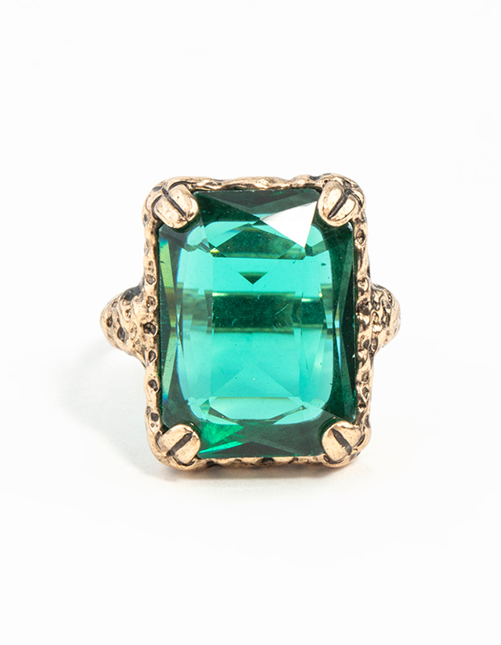 Highlighting an emerald square cut stone on gold band with faceted gem detail close up view