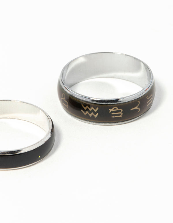 Highlighting celestial silver symbol mood ring set with black and gold detailing close up view