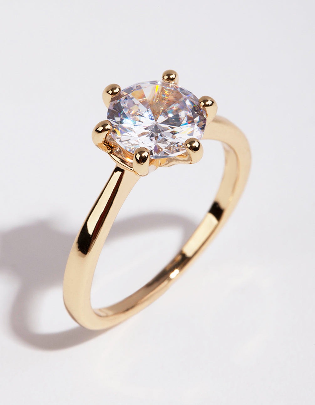 Showcasing a gold plated ring with round cubic zirconia featuring clear accents front view