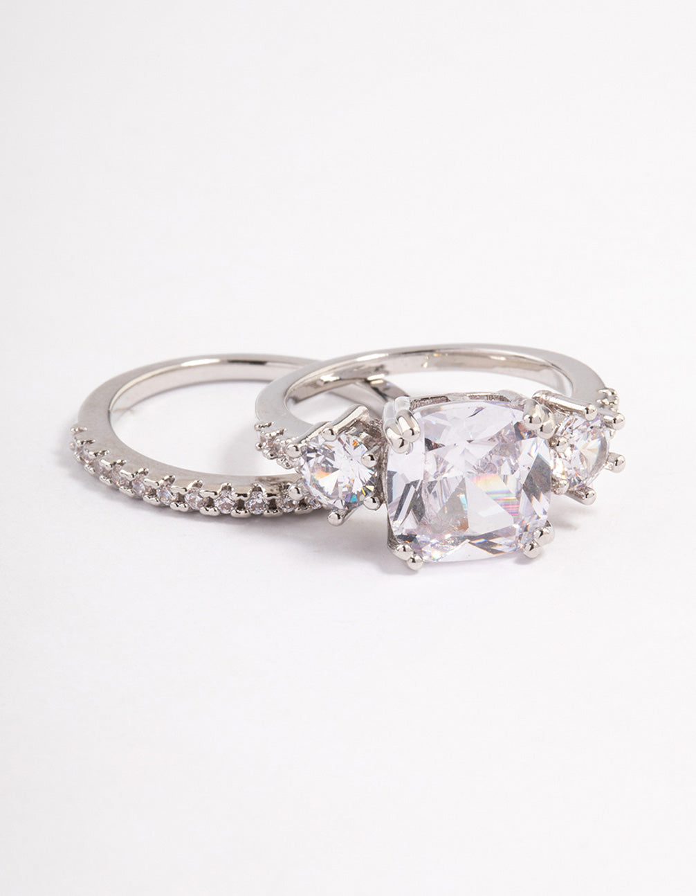Showcasing a triple stone ring set in silver featuring clear gemstones front view