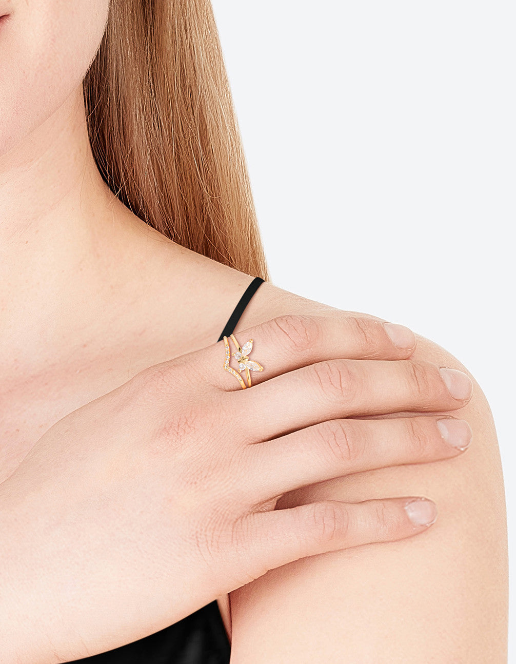Showcasing a gold plated cubic zirconia butterfly double band ring on finger view