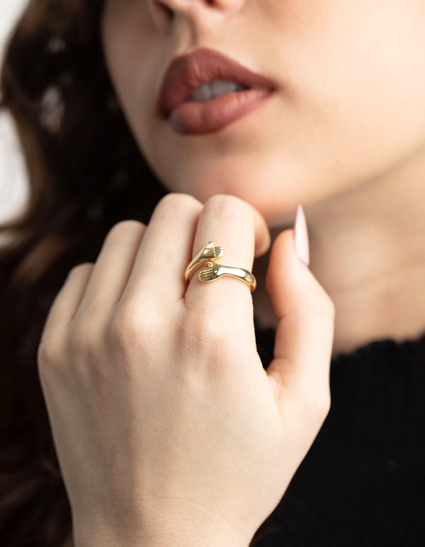 Crafted from gold plated material ring on finger view