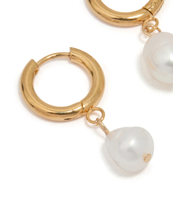 Beautifully crafted waterproof gold plated stainless steel freshwater pearl drop huggie earrings in white close up view