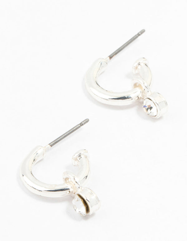 Showcasing simple diamante huggie earrings in silver front view