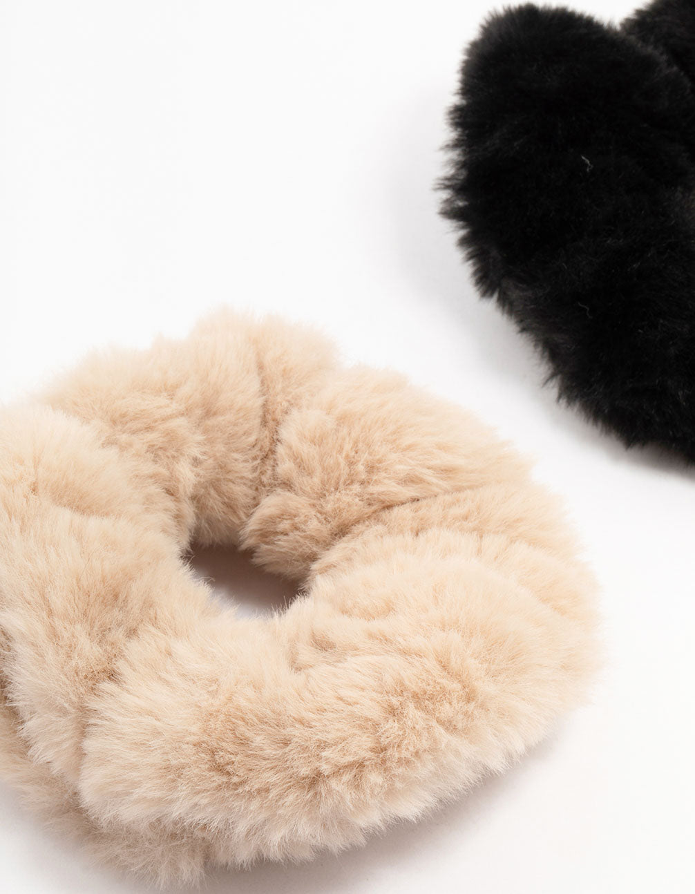 Crafted with solid faux fur, this 2-pack of scrunchies features black and tan side view