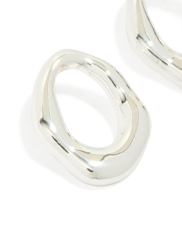 Highlighting molten open circle stud earrings in silver plated metal close up view