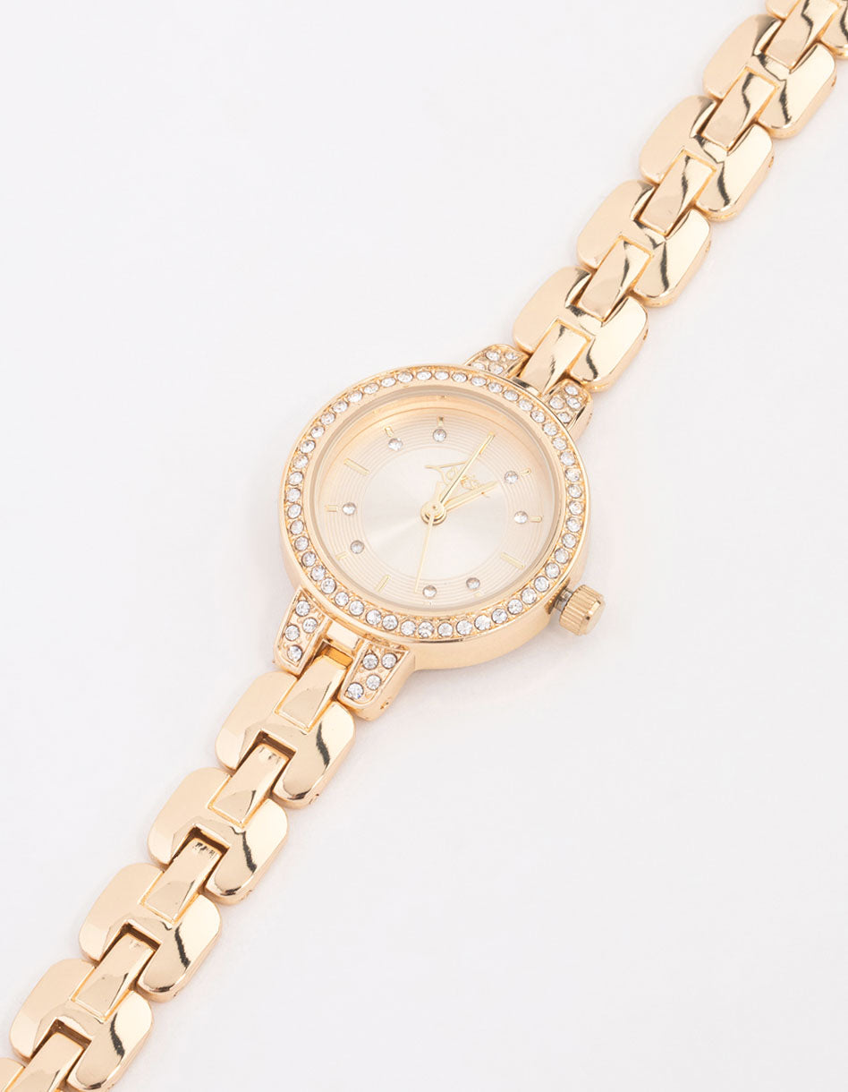 Elegant small diamante watch with white stone-embellished dial, round shape, formal styling, link-band strap in gold, and analog type watch face detail view
