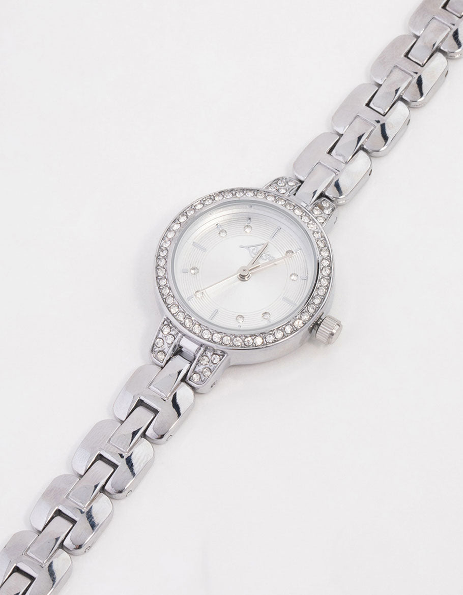 Showcasing a small silver diamante round strap watch with white stone look dial, round shaped face, casual women's analog timepiece featuring link band watch face detail view