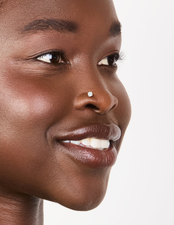 Showcasing titanium mixed diamante nose jewellery in a 6-pack with silver and gold finishes nose view