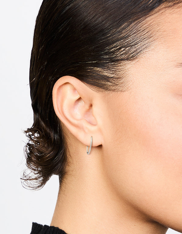 Showcasing surgical steel medium sleeper earrings, 12 mm in silver on ear view
