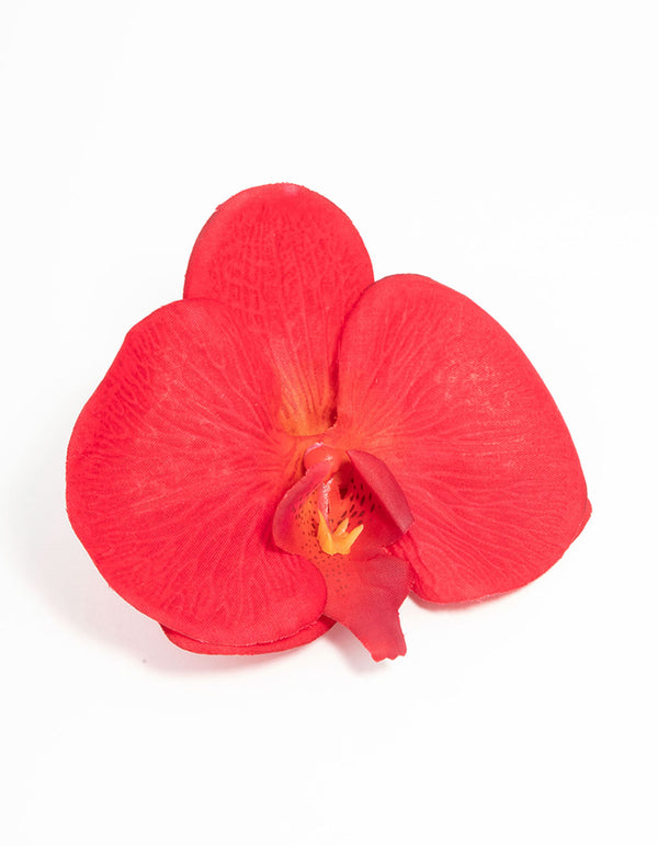 Showcasing a pink fabric orchid flower clip in coral, tomato, orange front view