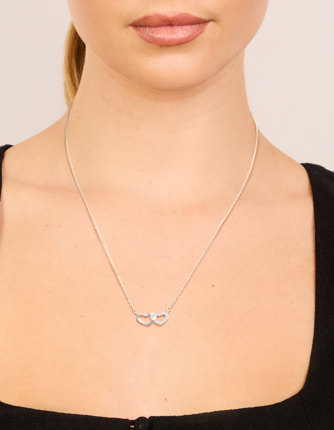 Crafted from sterling silver heart link necklace on neck view