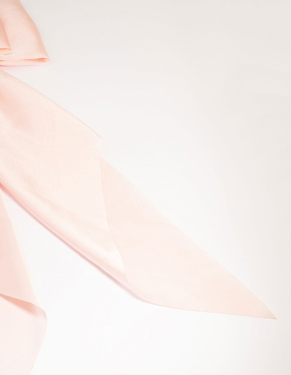 Featuring a pink satin fabric bow barrette clip with solid print side view