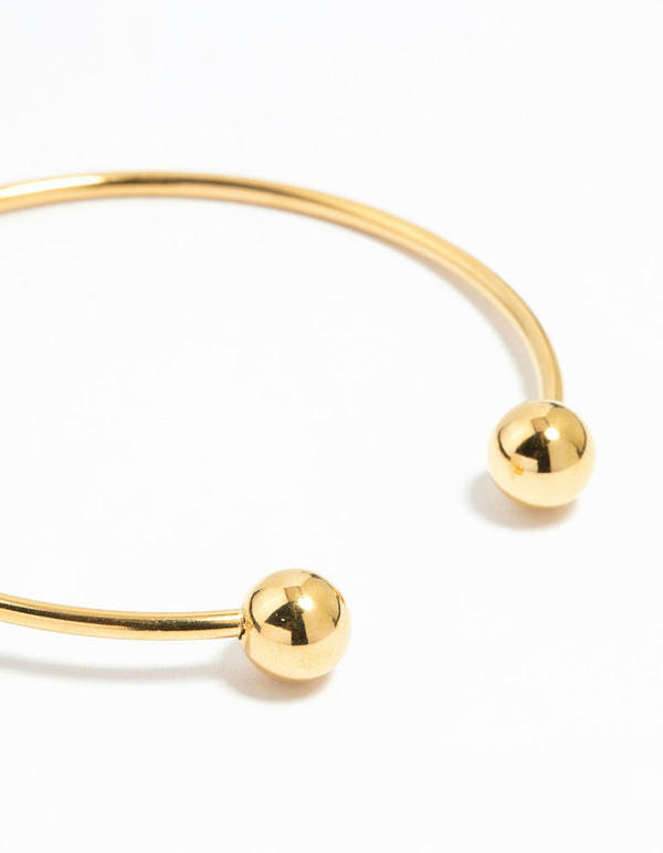 Featuring a waterproof gold plated stainless steel ball wrist cuff bangle close up view