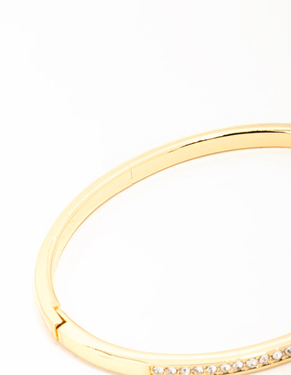 Featuring a gold diamante hinged bangle closure detail view