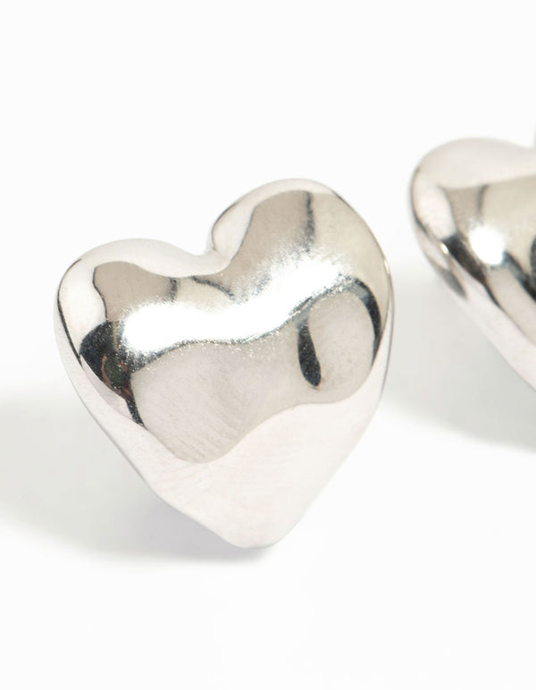 Designed with dainty stainless steel molten heart stud earrings featuring waterproof silver detail close up view