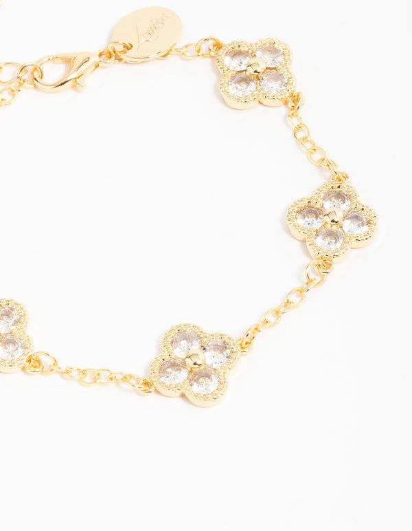 Crafted from gold plated cubic zirconia statement flower bracelet with charm detailing close up view