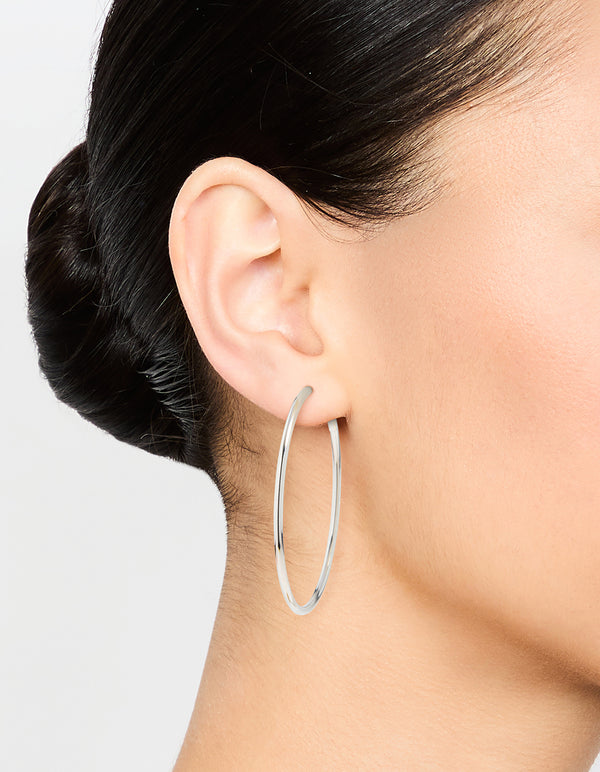 Discover statement hoop earrings, 50 mm in surgical steel with silver finish on ear view