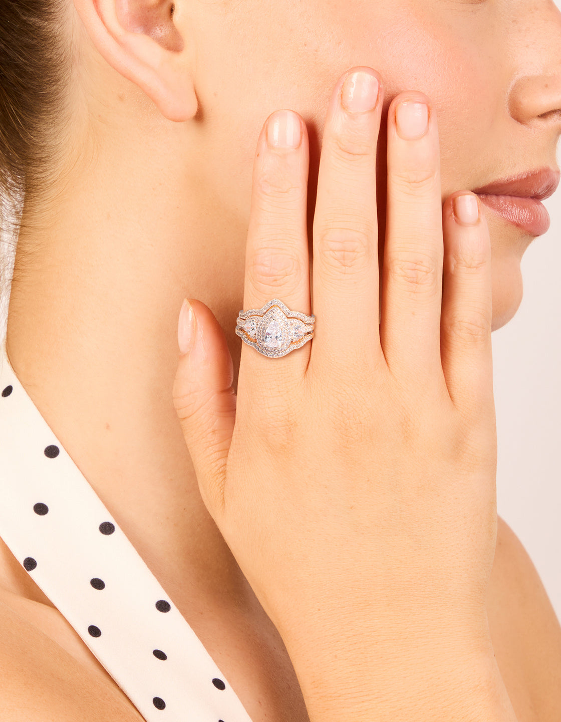 Showcasing rose gold pearl stacking rings in a dainty 3-pack on finger view