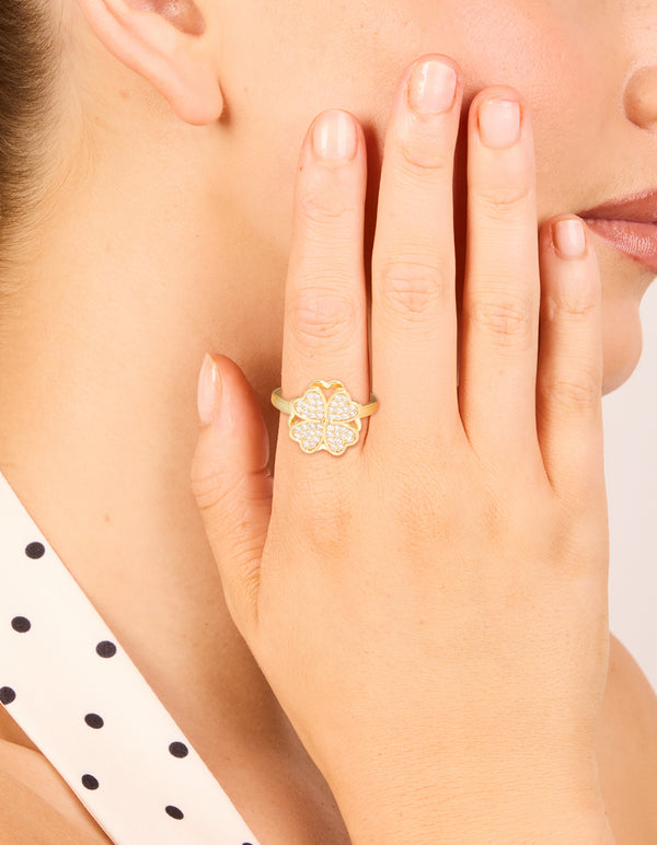 Beautifully crafted waterproof gold plated stainless steel spinning clover ring featuring floral and heart design on finger view