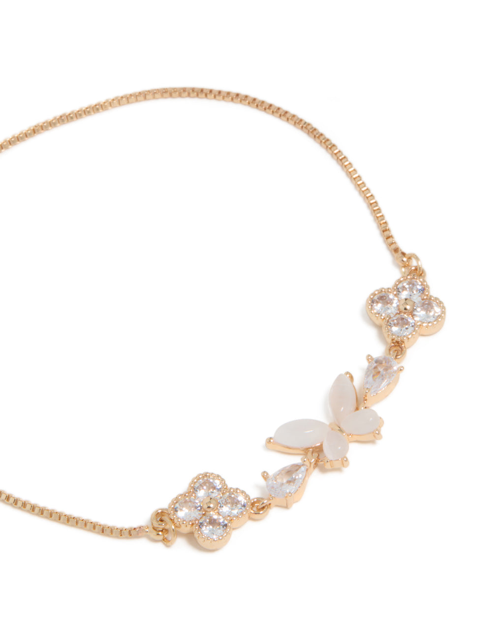 Detailed view of gold cubic zirconia butterfly and flower toggle bracelet in white with close up view