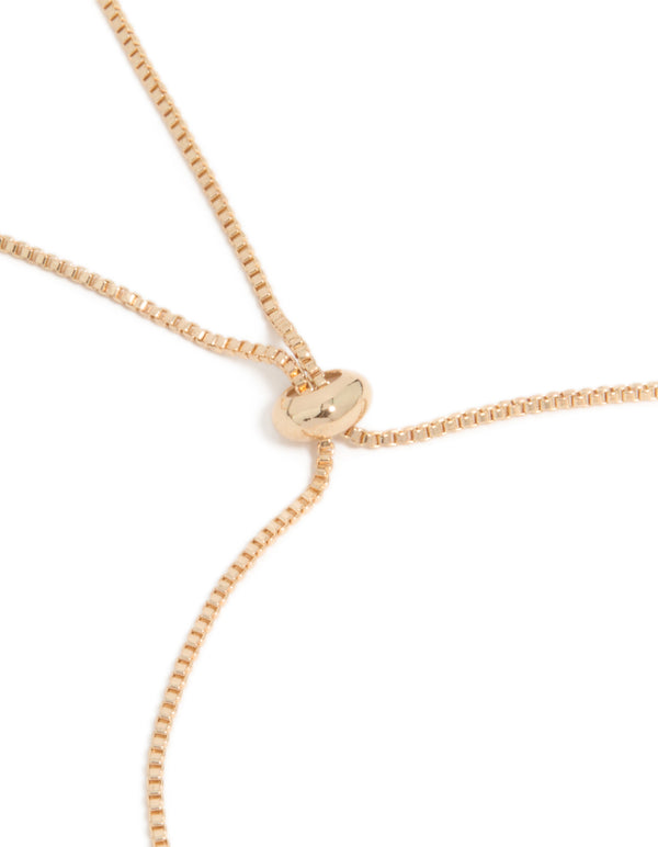 Close look at gold cubic zirconia butterfly and flower toggle bracelet in white with closure detail view