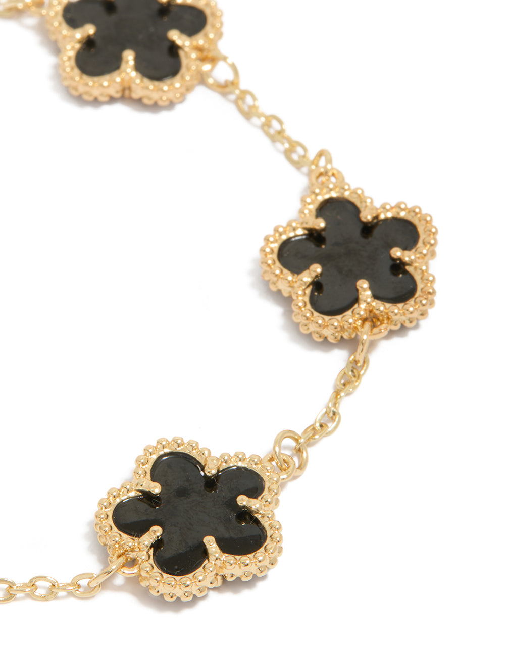 Featuring gold plated black flowers bracelet close up view