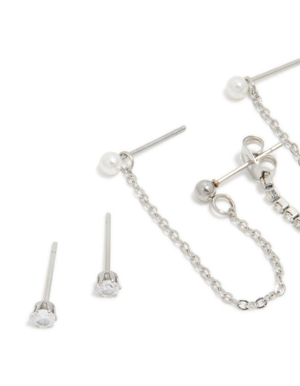 Featuring waterproof stainless steel cubic zirconia bow chain earrings with charm details and huggie closure in silver 3-pack close up view