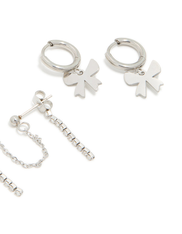 Crafted from waterproof stainless steel cubic zirconia bow chain earrings with charm details and huggie closure in silver 3-pack post detail view