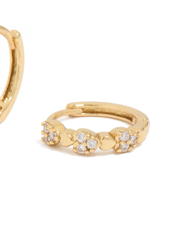 Elegantly designed mini heart huggie earrings featuring cubic zirconia stones in gold plated finish post detail view