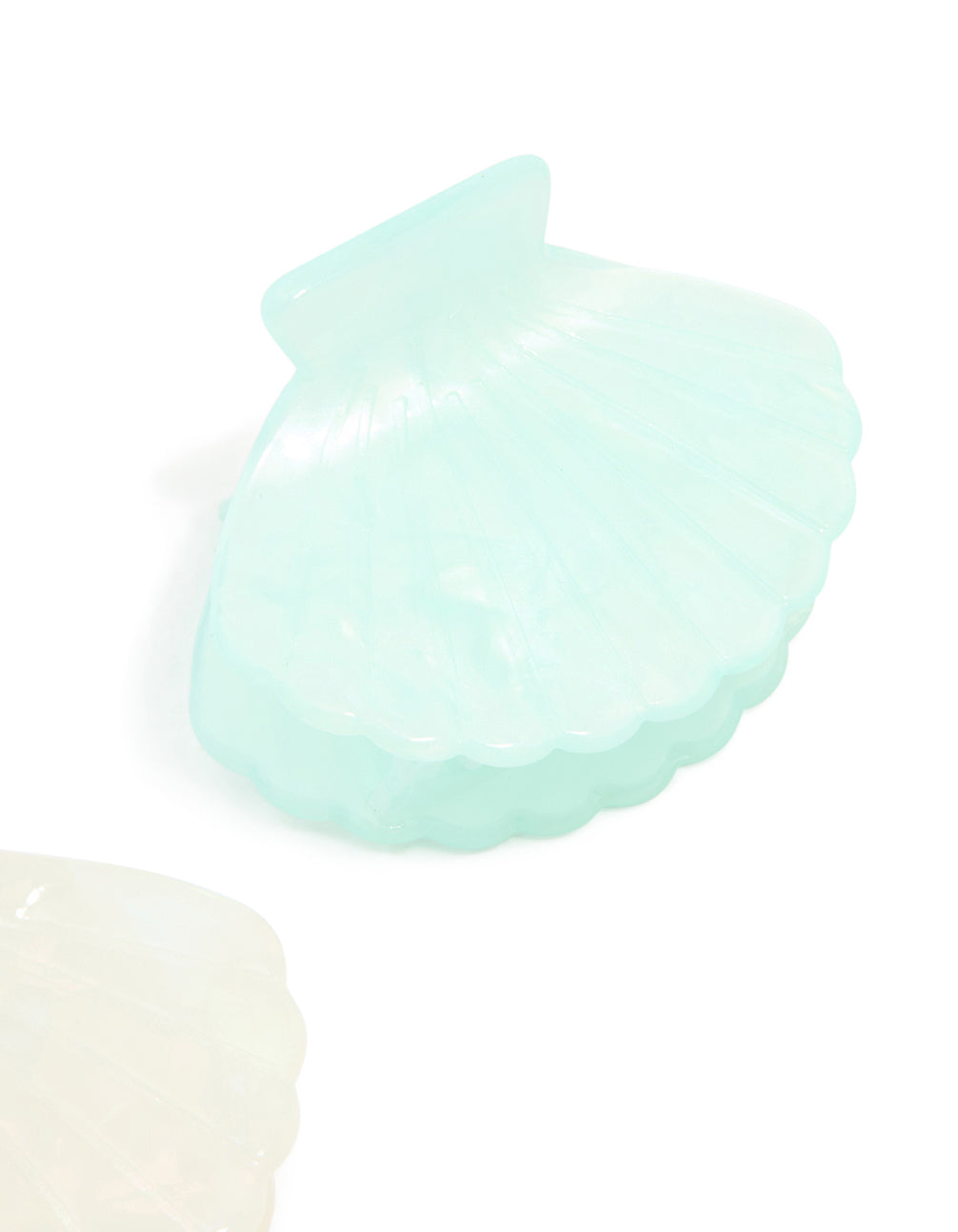 Featuring ocean-inspired shell design in solid pale turquoise and ivory, these claw clips come as a 2-pack accessories detail view