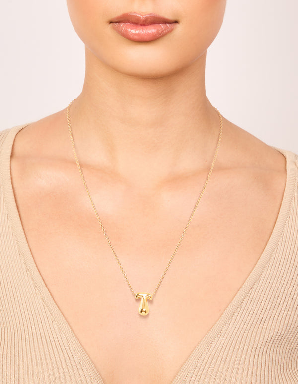 Elegant waterproof gold plated stainless steel bubble letter T necklace with initial pendant in dainty style on neck view