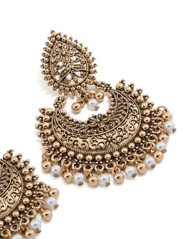 Crafted from antique gold teardrop pearl boho earrings featuring beads, charm, and floral elements post detail