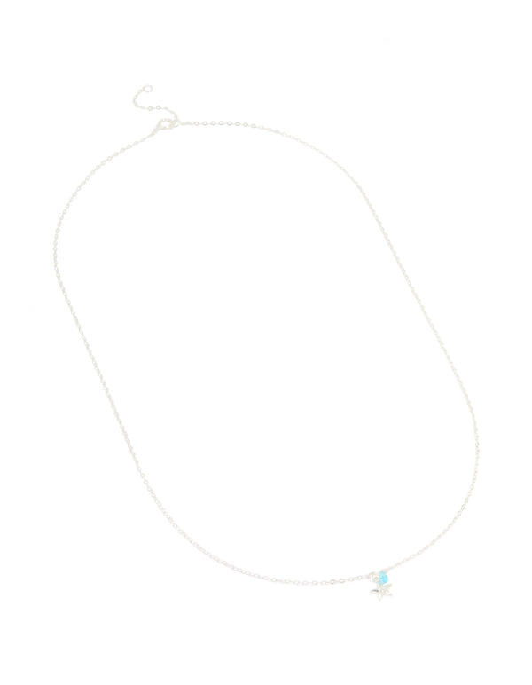 Featuring sterling silver construction, this blue cubic zirconia and starfish pendant necklace showcases ocean-inspired charm details with delicate crystal accents front view