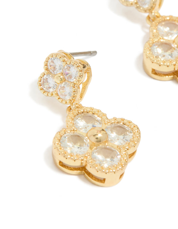 Elegant gold plated cubic zirconia small and medium flower earrings featuring a dainty clear stone design in close up view