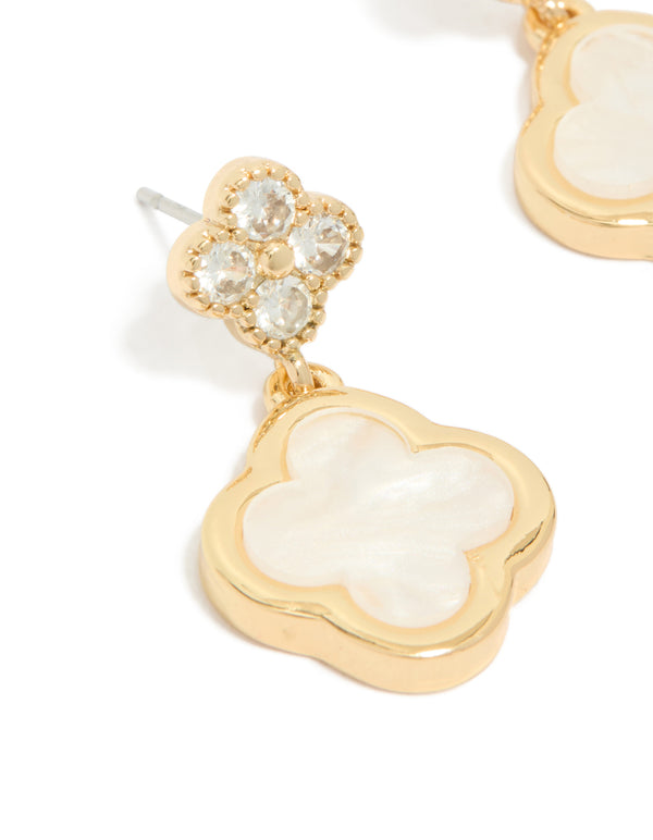 Elegant gold plated cubic zirconia drop earrings with double floral motif and ivory detailing close up view