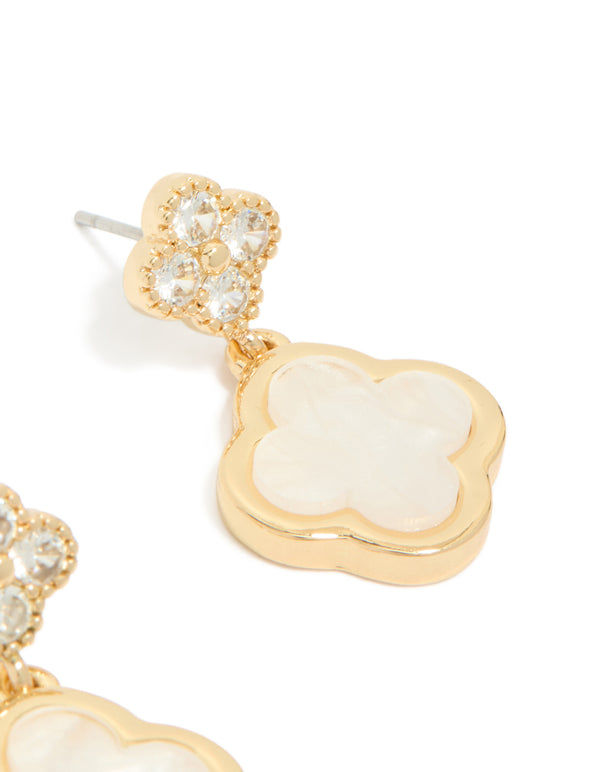 Elegant gold plated cubic zirconia drop earrings with double floral motif and ivory detailing close up view