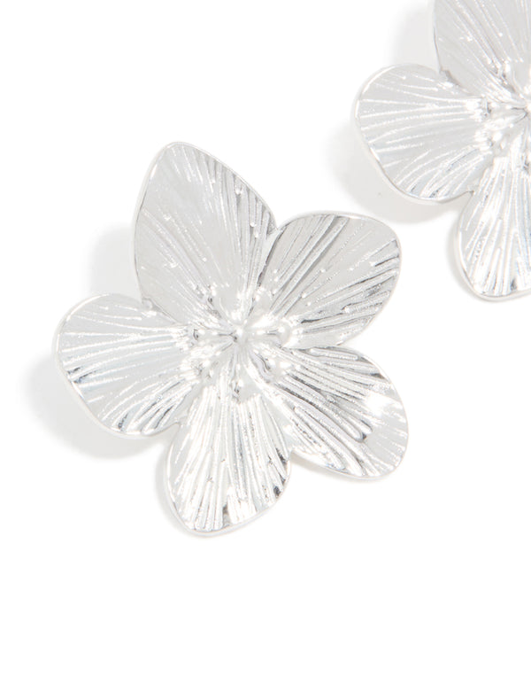 Highlighting intricate textured petal details of waterproof stainless steel flower stud earrings in silver finish close up view