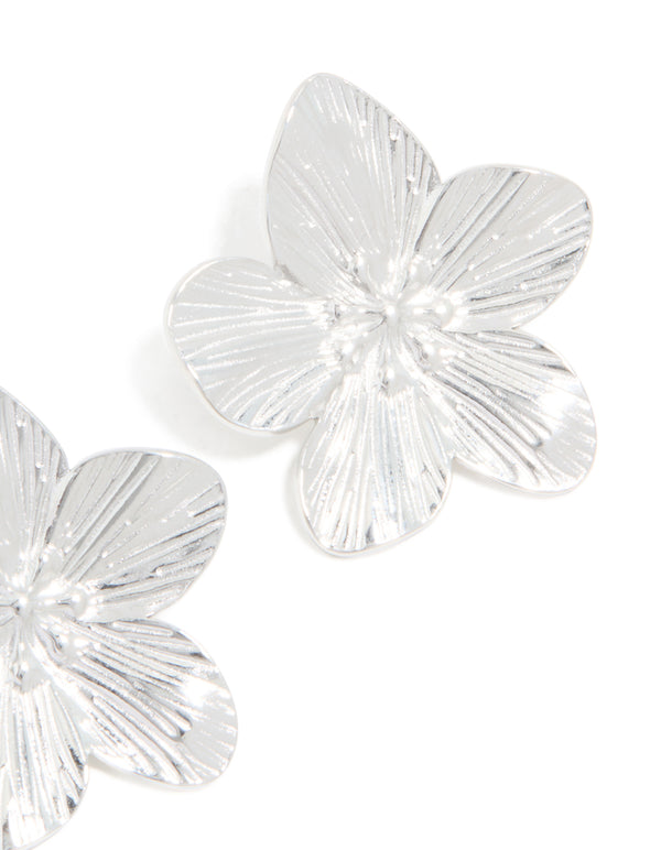 Detailed perspective of waterproof stainless steel textured flower stud earrings showcasing floral pattern in silver finish post detail view