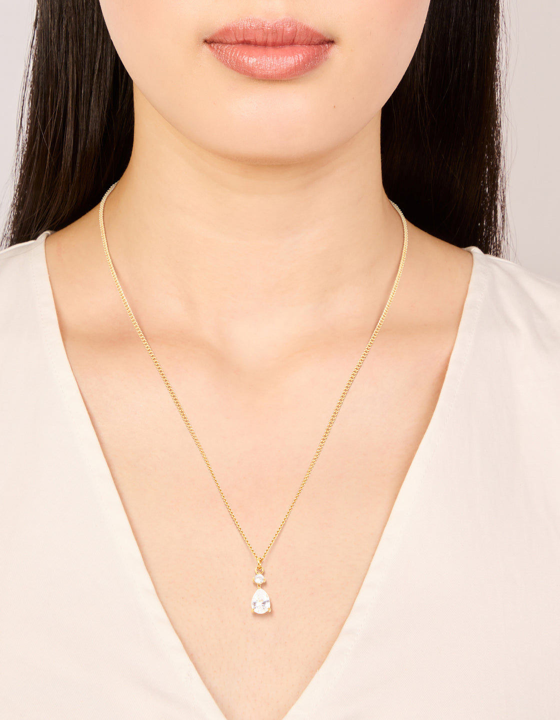 Discover this waterproof gold plated stainless steel cubic zirconia pear pendant necklace, crystal, and dainty style on neck view