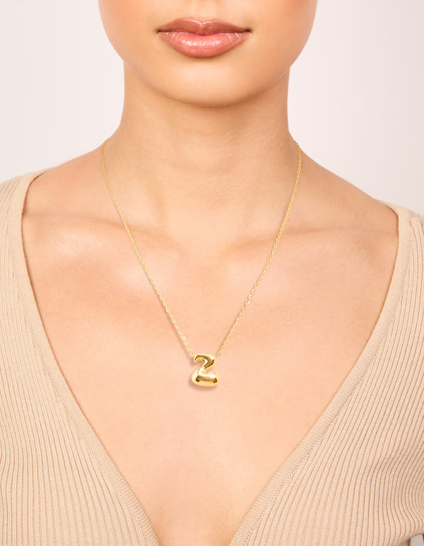 Featuring a waterproof gold plated stainless steel large bubble letter Z necklace with pendant and initials on neck view