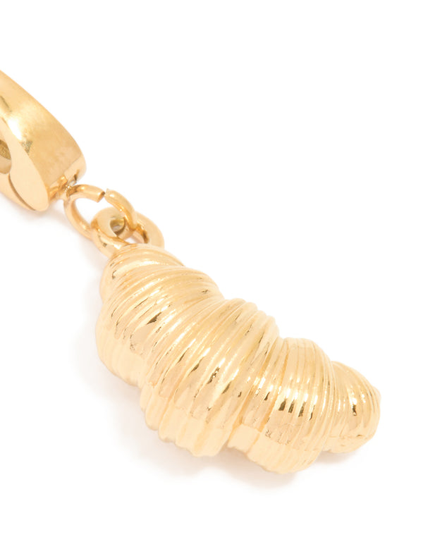 Showcasing a croissant charm in waterproof stainless steel with gold plated finish close up view